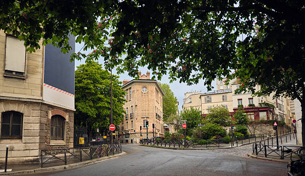 istock Empty parisian street corner with lush green trees 2221980102