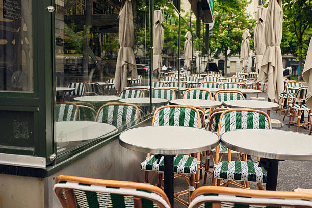 istock Empty parisian bistro tables and chairs waiting for customers 2221980108