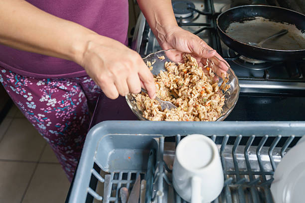 A kitchen worktop covered in unwashed crockery and recycling. Copy space.