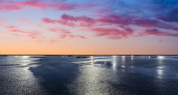 istock Wet asphalt road ground and beautiful sky clouds at sunset 2221984529