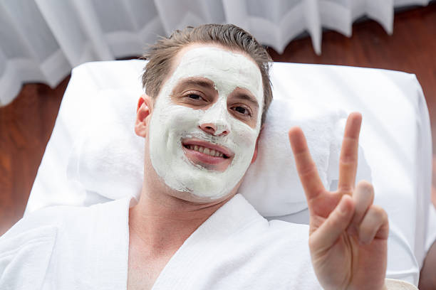 istock Man indulges in rejuvenating with luxurious face cream spa massage. Quiescent 2221990507