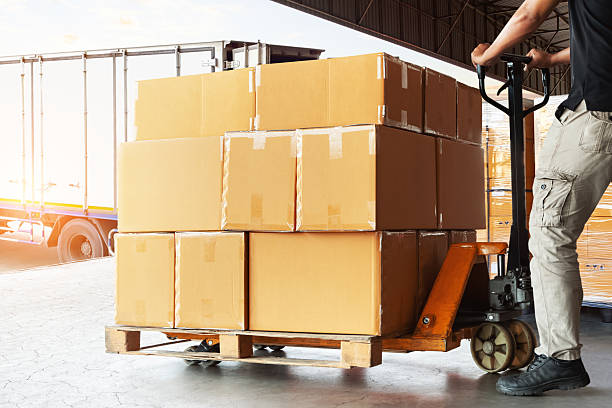 istock Workers Loading Package Boxes into The Truck. Forklift Pallet Jack. Package Boxes. Shipping Container. Distribution Warehouse, Supply Chain, Shipment, Freight Truck Logistics Transportation. 2221991183