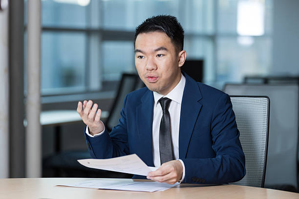 istock Young man discussing documents during a business meeting 2221992088