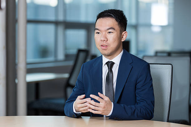 istock Young man giving a confident pitch during an office interview 2221992090