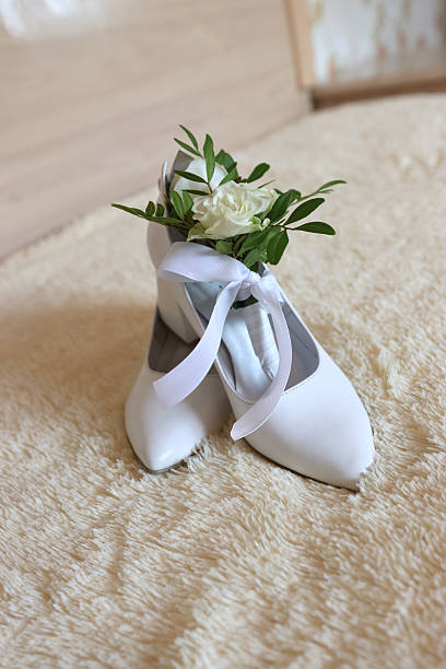 White rose and bride's shoes. Wedding preparations.