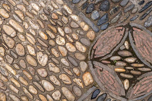 istock Traditional cobblestone pavement background, pebbles arranged in pattern. Ancient Chinese garden paving 2221994248