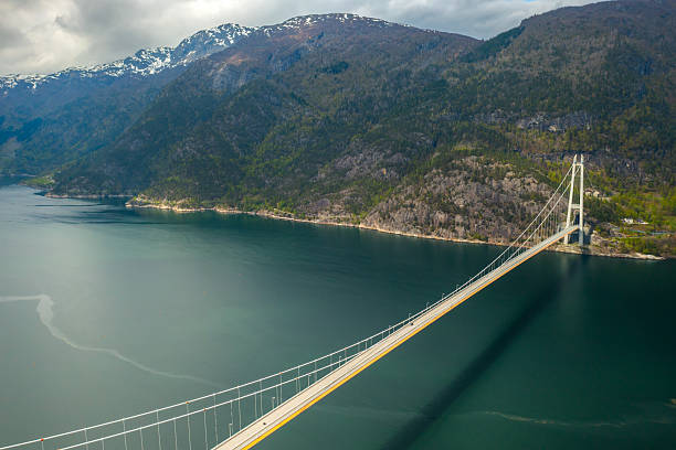 istock Hardanger Bridge with pylons and road extending across water 2221995135
