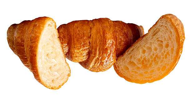 Top view of a loaf of brown croissant with two halves in stack isolated on white background with clipping path