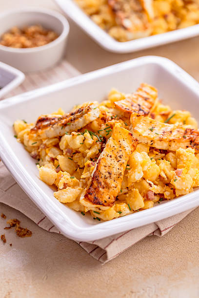 istock German egg dumplings with bacon, fried onions and grilled Halloumi cheese 2221997905