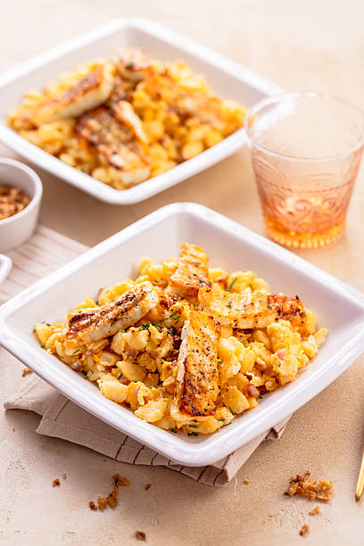 istock German egg dumplings with bacon, fried onions and grilled Halloumi cheese 2221997906