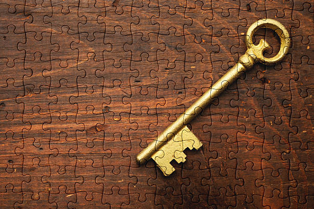 istock Skeleton key on a old wooden table made from Jigsaw puzzle 2221998856