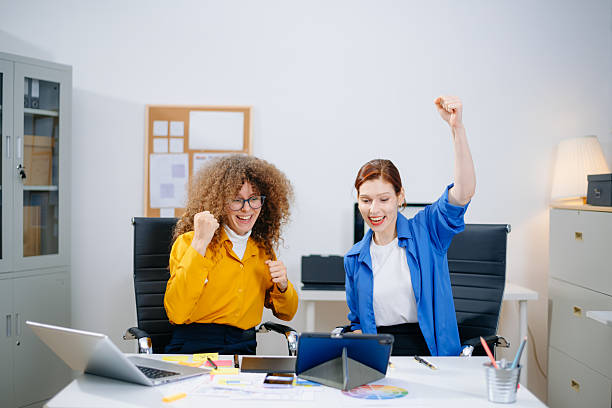 istock Creative female team celebrating a successful project in a modern design office. Real people, joyful teamwork 2221998902