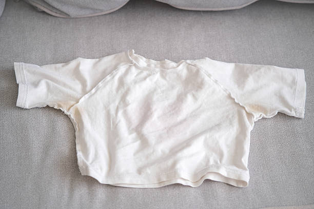 istock A yellow spot on a white T-shirt. Top view. 2222000979