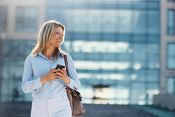 istock Happy female entrepreneur using mobile phone on the move. 2222002680