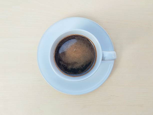 istock Black coffe in white glass on wooden table background 2222003033