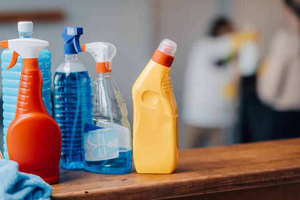 istock Cleaning products on table with cleaning staff working in background 2222005036