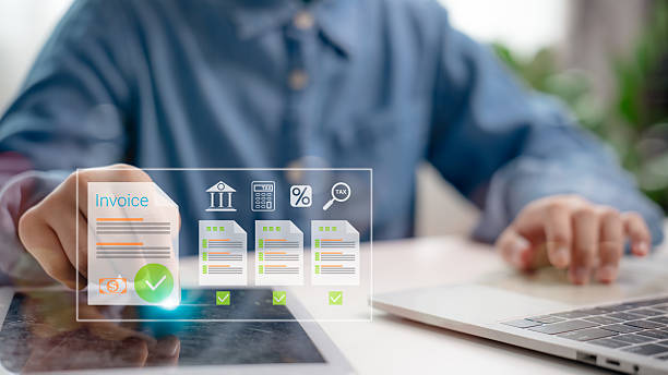 istock Hand interacting with e-invoice on tablet screen, digital financial documents and icons, concept of online billing, tax management, and electronic financial statements. 2222005964