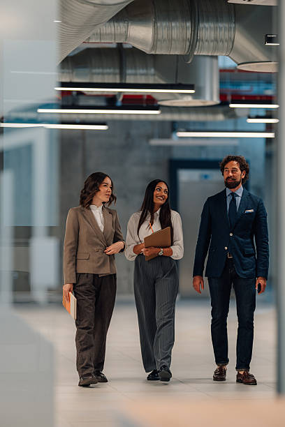 istock Businesspeople walking and talking in modern office building 2222006562