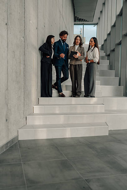 istock Business team discussing strategy on modern office stairs 2222006583