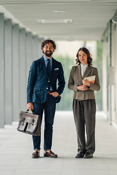 istock Smiling business people standing in modern office hallway 2222006640