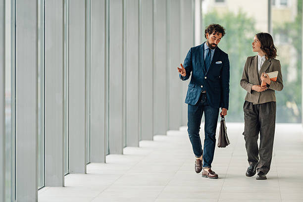 istock Businesspeople walking and talking in modern office building 2222006641