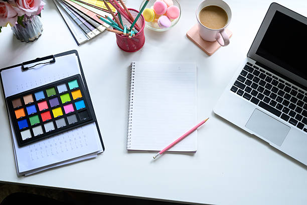 istock Overhead view of creative graphic designer workspace with laptop and color palette tools 2222006749