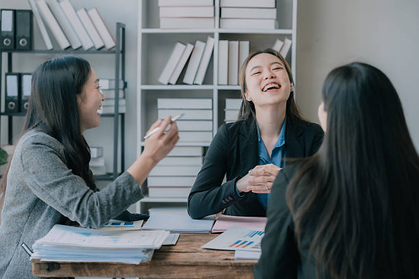 istock Three Asian business women making money from document graphs, analyzing ideas, teamwork, collaboration and planning with documents or business strategies in the office. business starting concept 2222007179