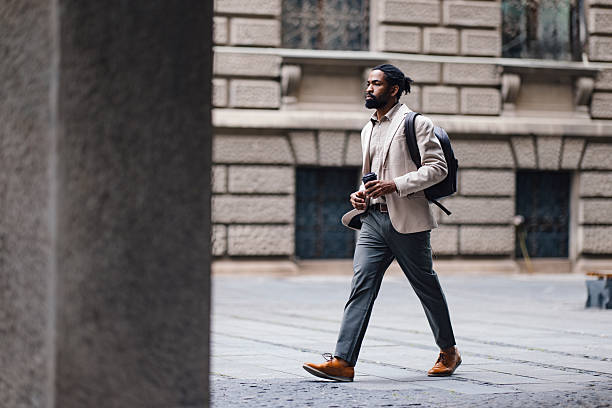 istock Businessman Walking Outdoors with a Coffee and Backpack in an Urban Setting 2222011182
