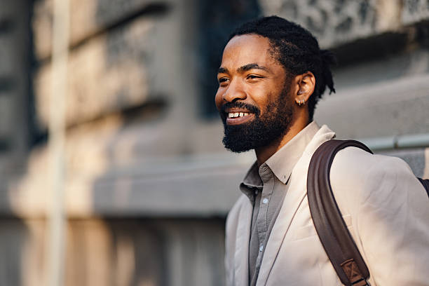 istock Confident Businessman Smiling Outdoors in Professional Attire During a Sunny Day 2222011186
