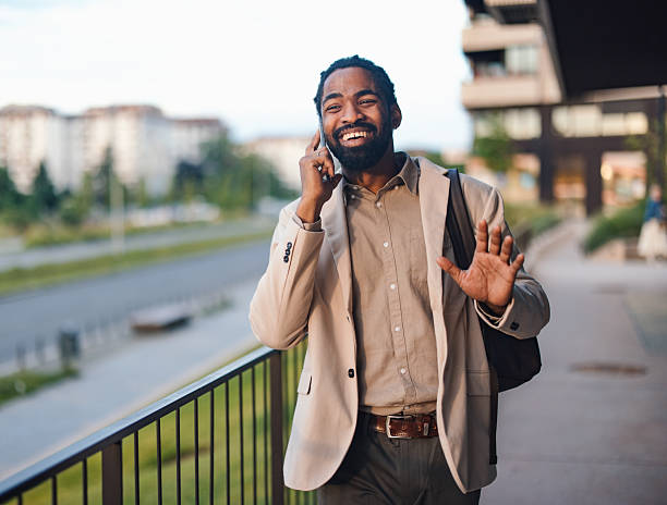 istock Smiling Businessman Talking on Phone Outdoors by Urban Setting 2222011243