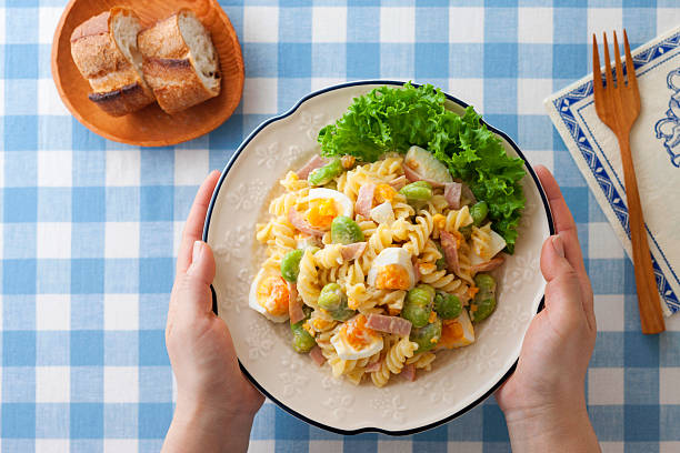 A charming spring-colored salad featuring fava beans and macaroni, both in season from spring to early summer.