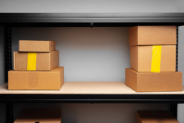 istock Rows of shelves with cardboard boxes in modern warehouse 2222014430