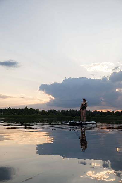 istock Paddleboarding at Sunset on a Tranquil Lake 2222014650