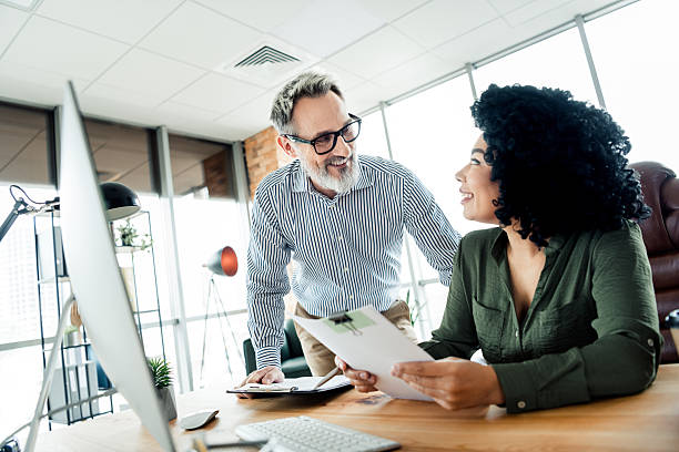 istock Professional collaboration between diverse coworkers in an office workspace, focusing on teamwork 2222016047