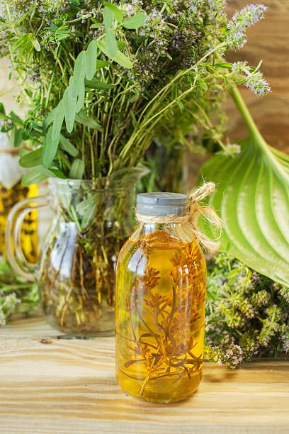 istock Herbs, spices, tinctures and vegetable oils on a wooden background. 2222016065