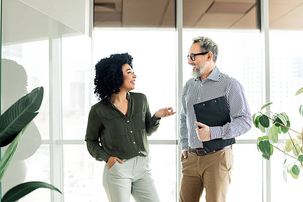 istock Business professionals engaged in a collaborative conversation in a bright office environment showing teamwork and cohesion 2222016092