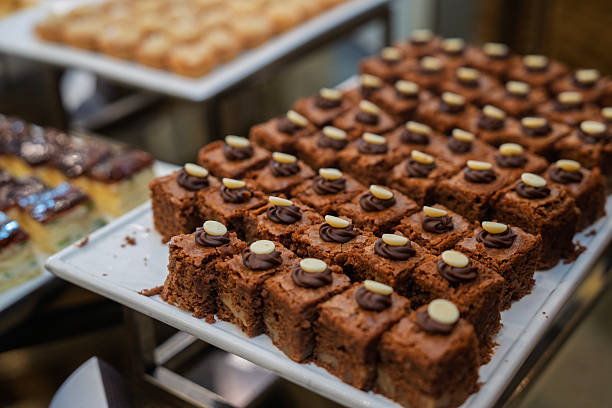 Chocolate walnut cakes topped with chocolate ganache and white chocolate buttons