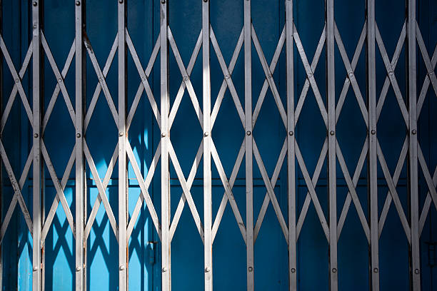 Industrial texture. Urban security. Rusted Metal Folding Door Background Texture.