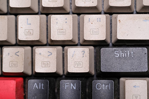Close-Up View of a Dirty Computer Keyboard with Crumbs and Dust