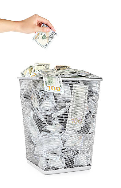 istock Woman throwing dollar banknote into trash bin on white background, closeup 2222024696