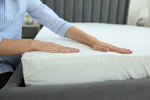 istock Woman changing clean bed linens at home, closeup 2222024825