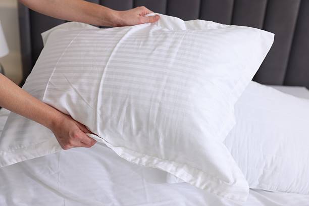 istock Woman changing clean bed linens at home, closeup 2222024829