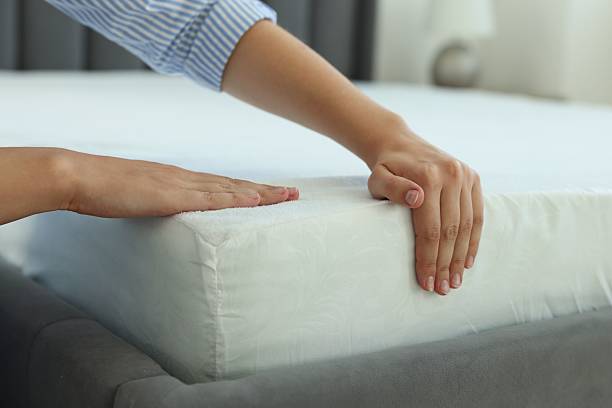 istock Woman changing clean bed linens at home, closeup 2222024844