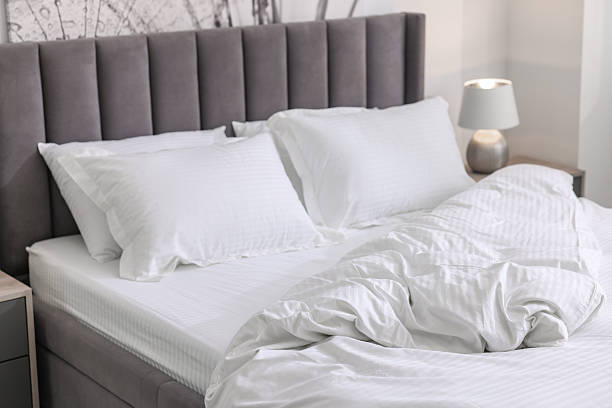 istock Bed with clean linens and pillows at home 2222024873