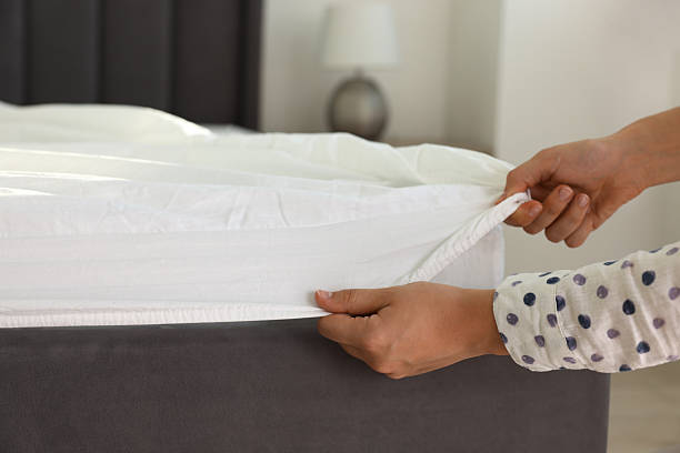 istock Woman changing clean bed linens at home, closeup 2222024875