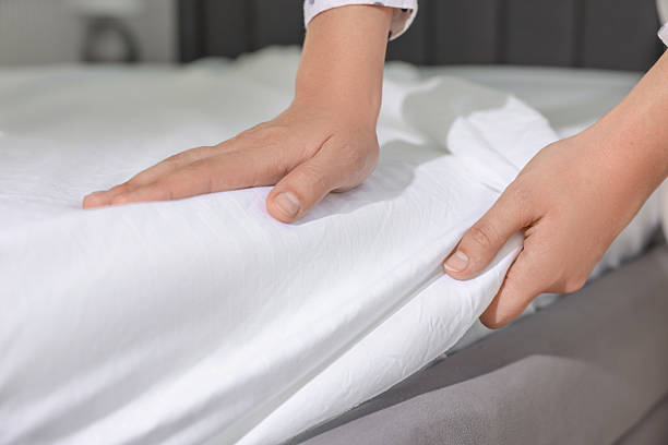 istock Woman changing clean bed linens at home, closeup 2222024918