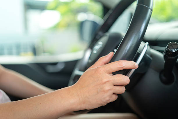istock A car driver is holding and controlling on steering wheel. 2222028063