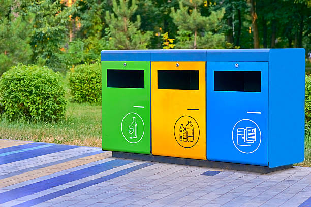 istock Ecology. Separate waste containers for plastic, paper and glass in a summer park 2222028466