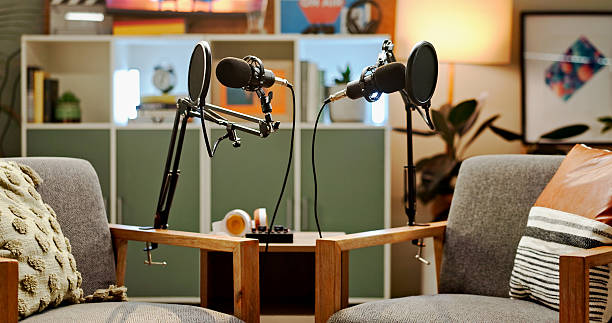 istock Microphone, podcast and setup for live streaming in studio, broadcast and announcement. Equipment, empty room and recording for talk show with radio service, streamer session and entertainment audio 2222031627
