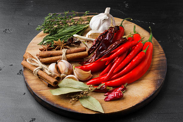 istock Garlic cloves and spices on black background 2222034139